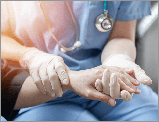 Medical professional examining the hand of a patient with a bleeding wound inflicted by a bat that may have rabies.