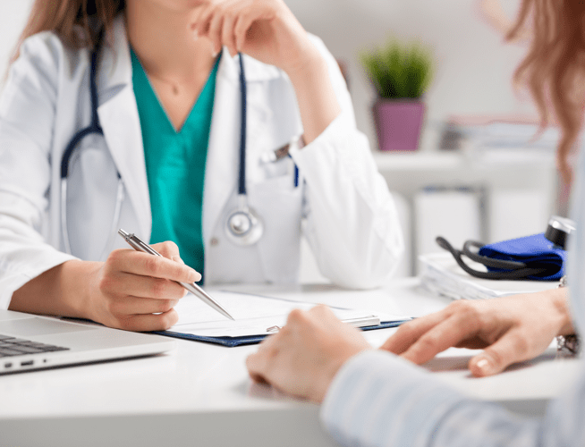 Medical professional conferring with caregiver about the threat of rabies exposure.